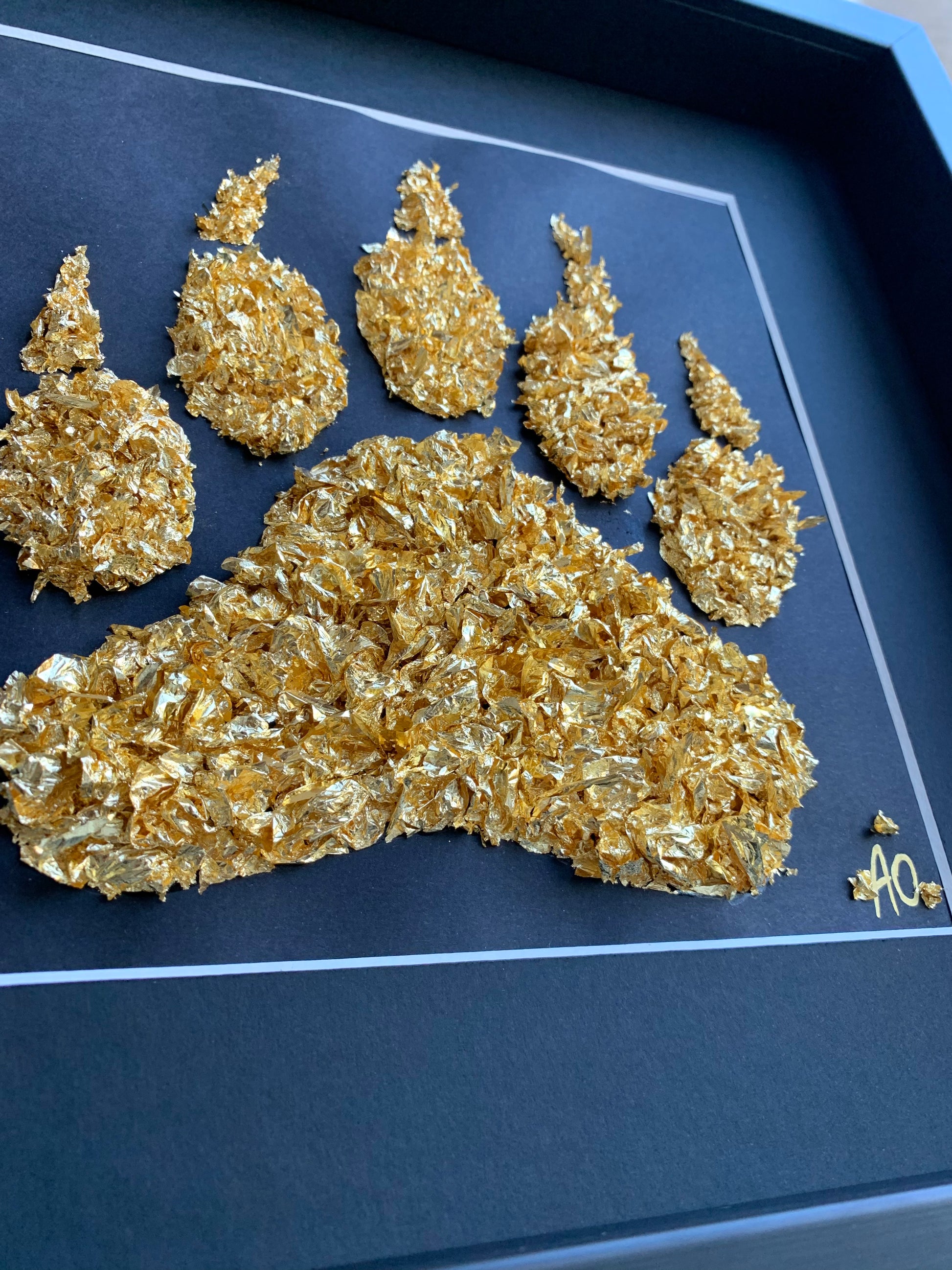 Tableau d'une patte d'ours en feuilles d'or fait par L'ours Doré